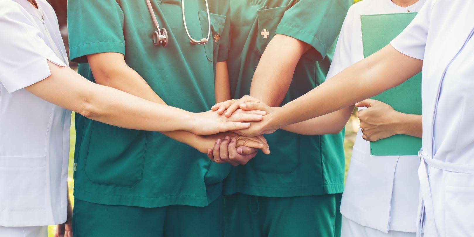 nurses holding hand together